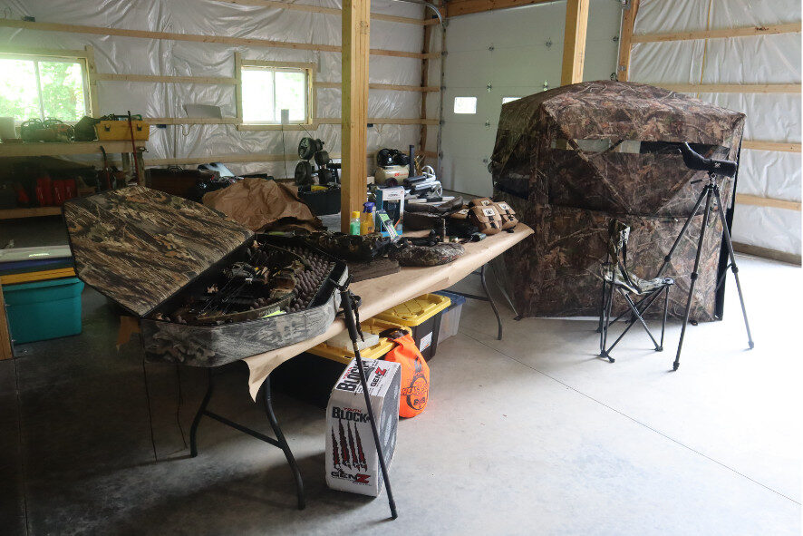 hunting gear displayed on a table in the newly built building on Christopher's property