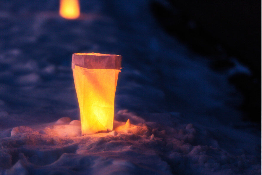 glowing lantern on a snow-covered trail
