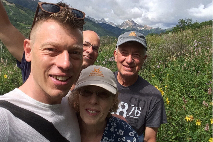 four people taking a selfie while on a hike