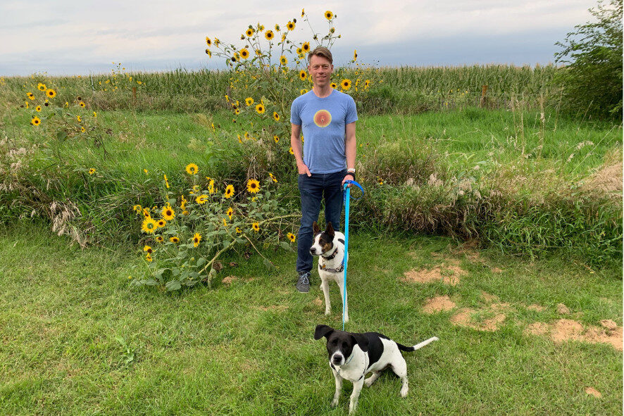 person walking a dog in a prairie