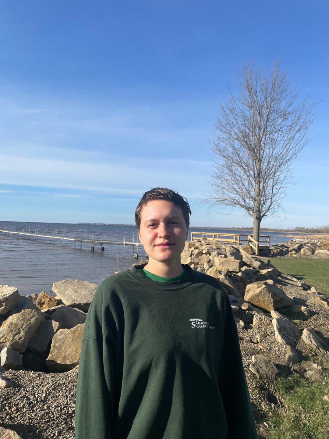 person standing next to a rocky shoreline