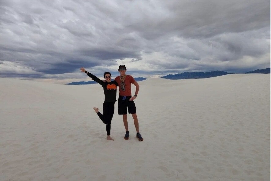 two people standing on the sand dunes at White Sands National Park