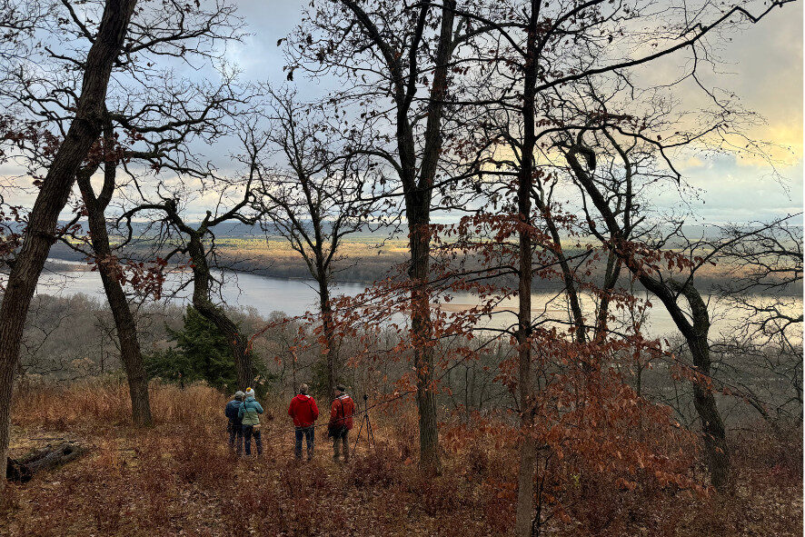 people standing on a bluff overlooking the Wisconsin River in the Driftless Region at dusk