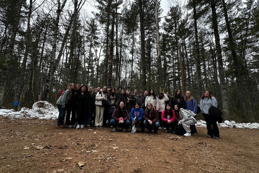 Students pose for a group photo in the Superior School Forest