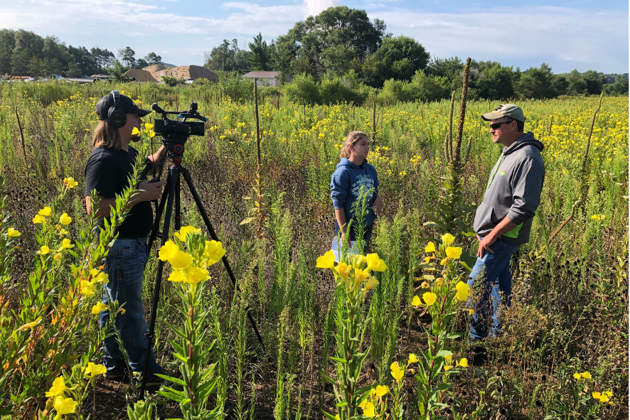 people standing in a prairie being filmed, image for protect your local pollinators blog post