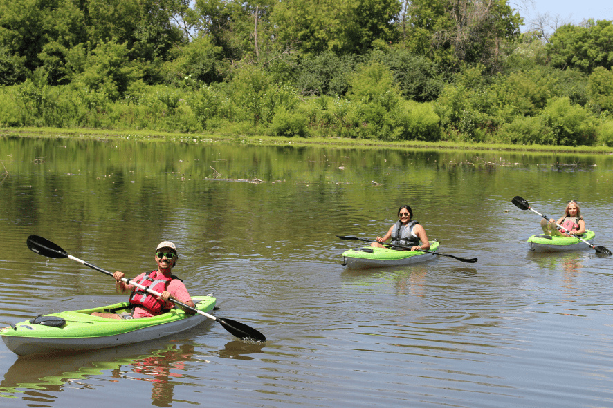 three people kayaking on the Milwaukee River