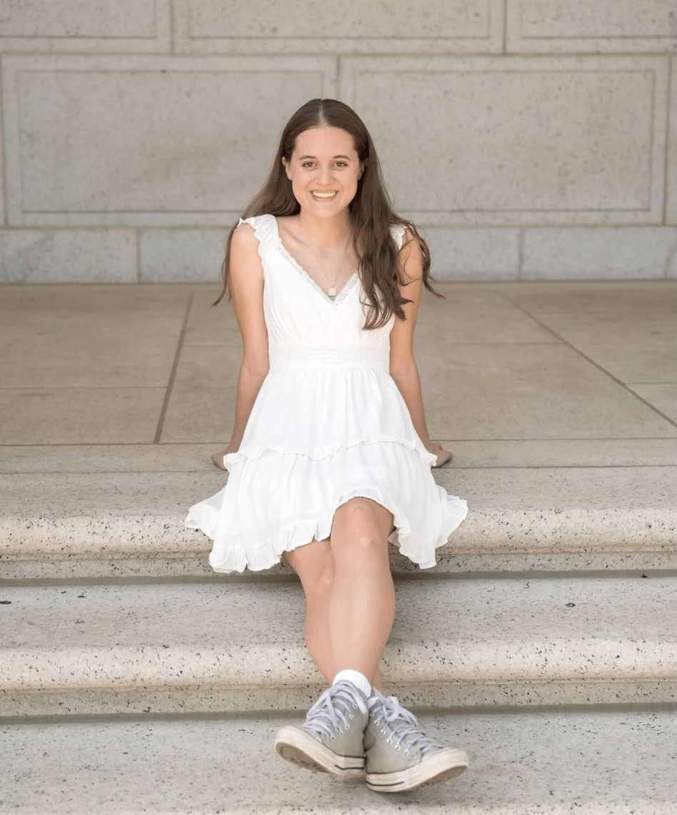2024 Diversity in Conservation Internship cohort member sitting on the steps of a building
