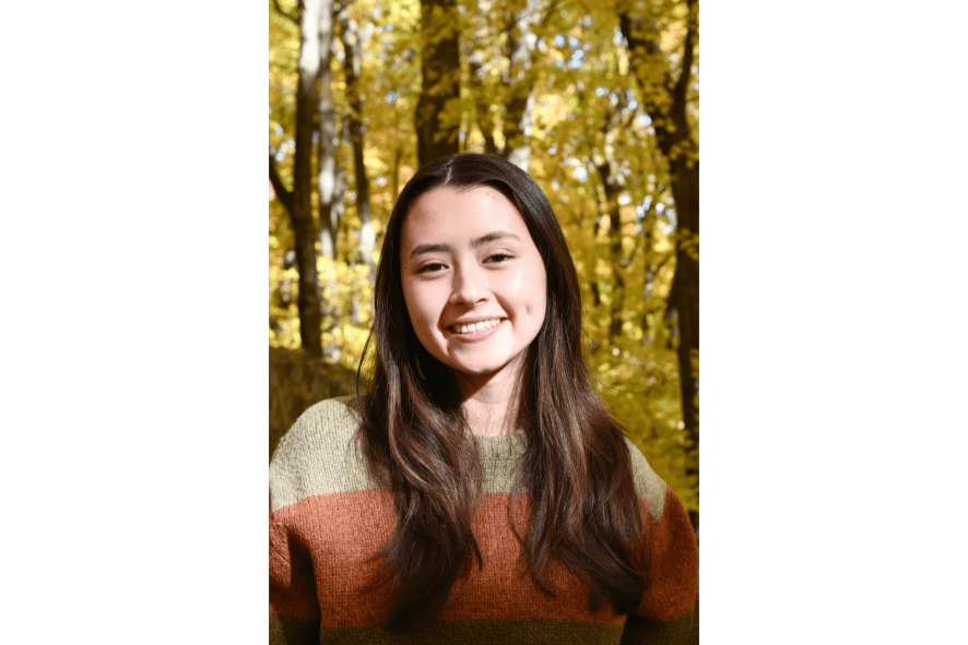 close up of Marie standing in an autumnal forest